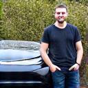 Eco-conscious customer Alex T. with Tesla